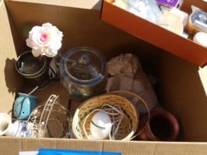 box of home decor - how to ruthlessly purge your stuff