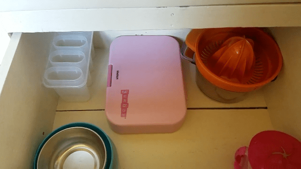 minimalist kitchen drawer with kids bowls and containers
