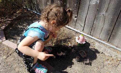 girl playing with her DIY fairy garden